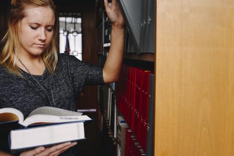 student in library